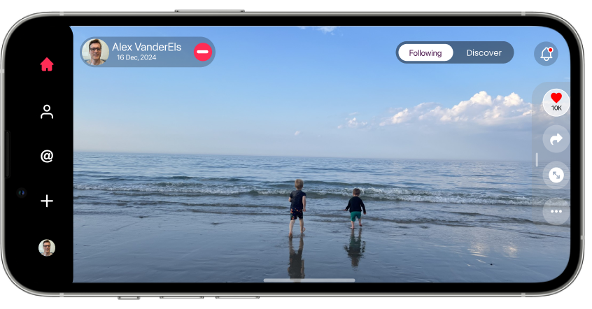 Two kids wading into the ocean, shown full width